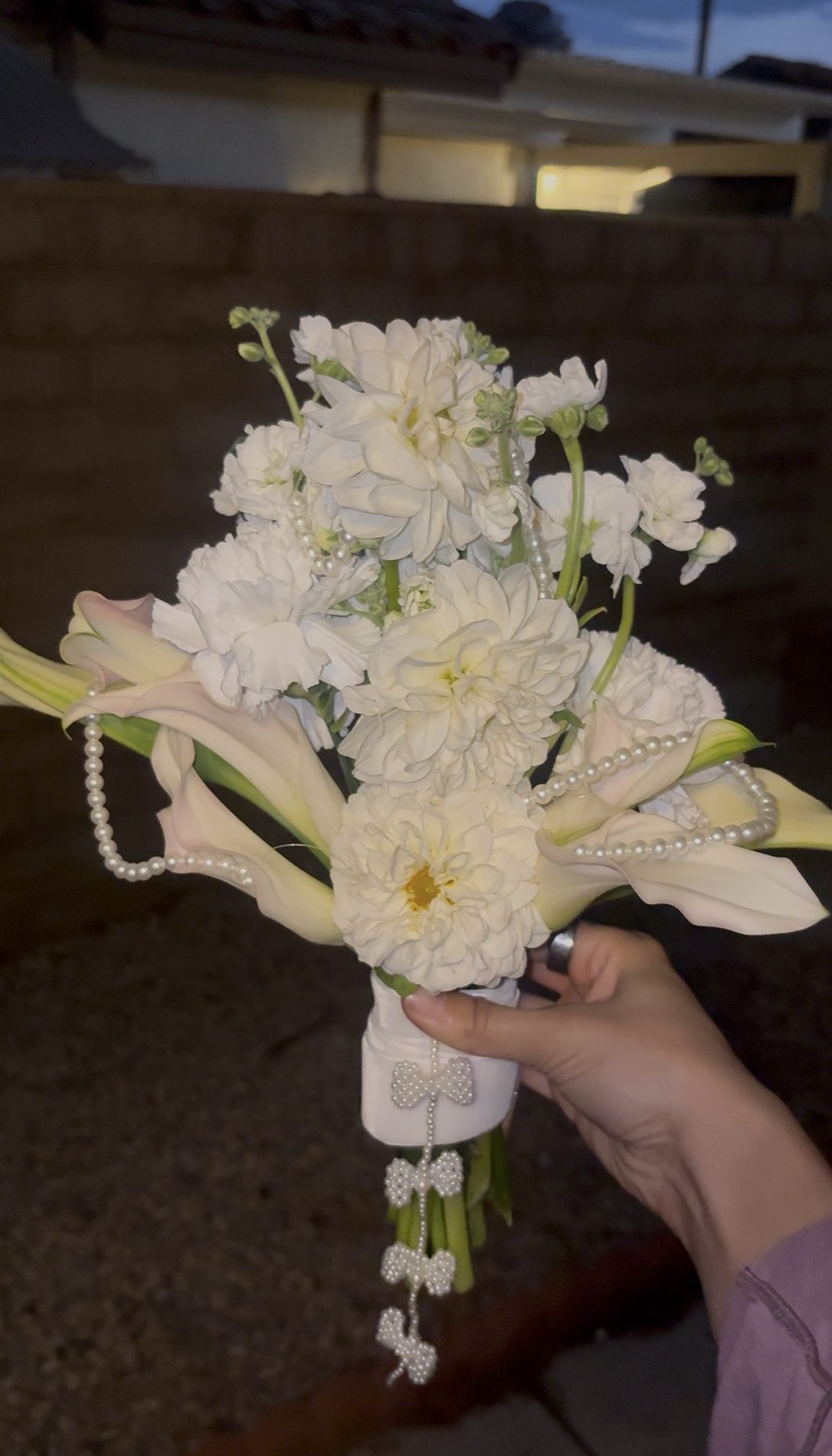 White bridal bouquet with calla lilies and pearl details