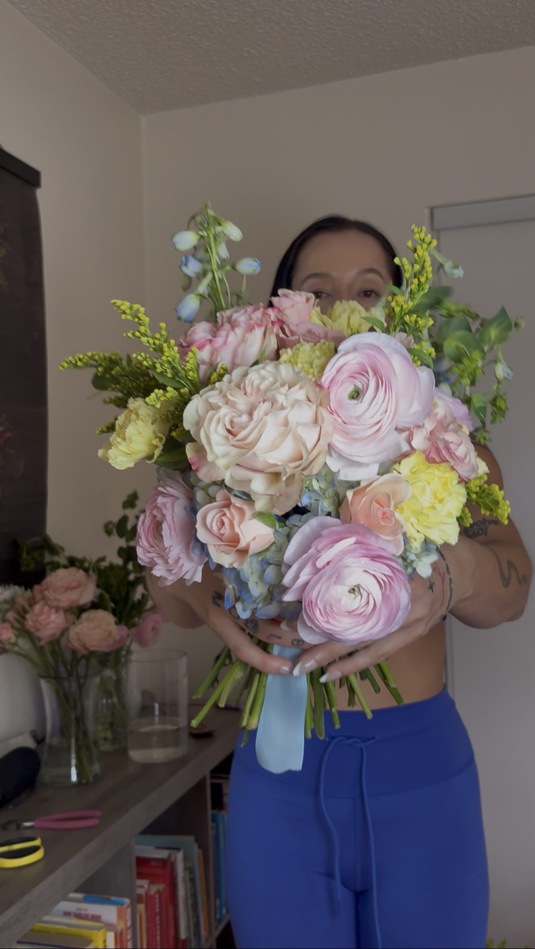 Florist holding original pastel bouquet in studio