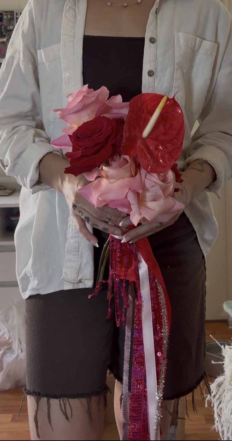 Original red and pink bouquet with dramatic ribbon details